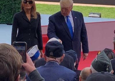 President Trump and first lady in Normandy shaking hands with US WWII veterans