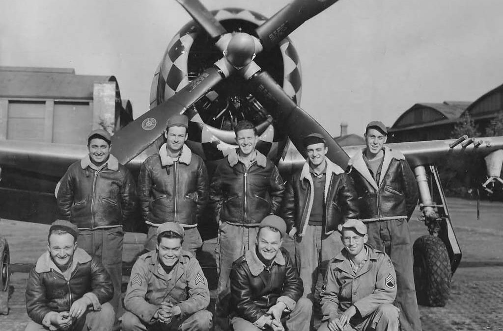 lt col bob wilkerson and co in front of wwii fighter plane