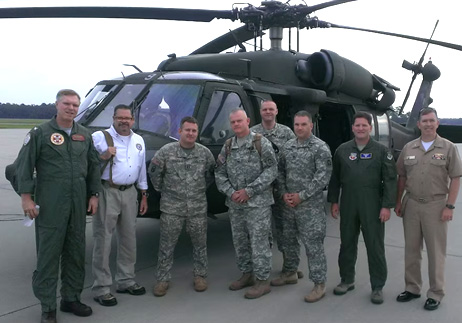 us military standing next to helicopter
